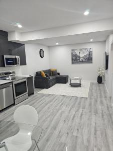 a living room with a couch and a table at Cozy on Baywater in Airdrie +15 photos