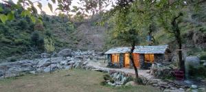 a small cabin in the middle of a mountain at Khoj Cottage & Cafe in Dharmsāla