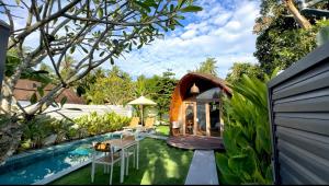a backyard with a gazebo and a swimming pool at Found Mansion Langkawi in Pantai Cenang