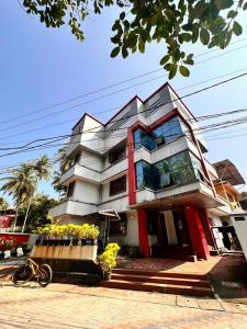 a tall building with flowers in front of it at devanjana inn in Jāmb