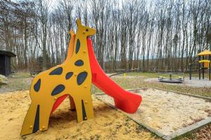 a playground with a giraffe on a slide at Schönes Ferienhaus Am Twistesee in Bad Arolsen