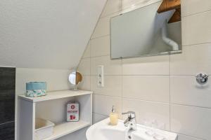 a bathroom with a sink and a mirror at Schönes Ferienhaus Am Twistesee in Bad Arolsen +13 photos