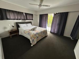 a bedroom with a bed and a window at Northcote holiday home- Next stop CBD in Auckland