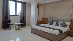 Ένα ή περισσότερα κρεβάτια σε δωμάτιο στο Sai Inn