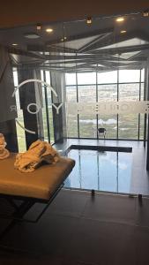 a swimming pool with a bed in a room at Hotel Yoru in Querétaro