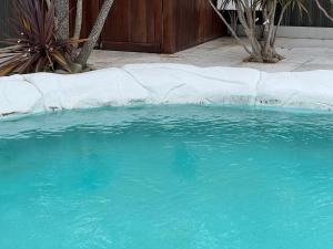 a large pool of blue water in a yard at Palacete Beach Resort in Culburra Beach +18 photos