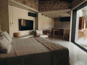 a bedroom with a bed and a table and a window at Mikro 1940 in Mesogi +42 photos