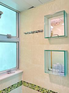 a bathroom with a mirror and a shower at Metacity MK 名廸旺角 in Hong Kong