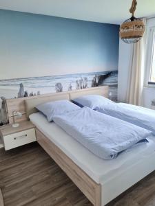 a bedroom with a bed with a beach mural on the wall at Fh Rügenblick in Stralsund