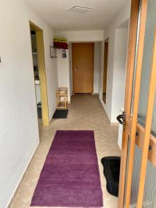 a hallway with a purple rug on the floor at Modern Gemütlich in Pflach