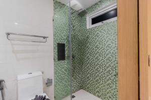 a shower with a glass door in a bathroom at C245 Steps from the Beach Pool & Ocean View in Ban Saiyuan (1) +19 photos