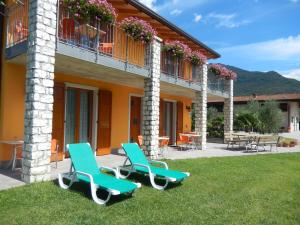 a house with two chairs and a patio at Agritur Giovanazzi in Arco