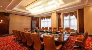 a large meeting room with a long table and chairs at New Century Grand Hotel Xinxiang in Xinxiang +222 photos