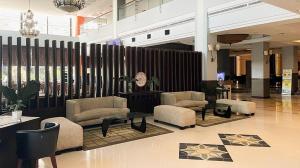 a lobby with chairs and tables in a building at Grage Hotel Cirebon in Cirebon +206 photos