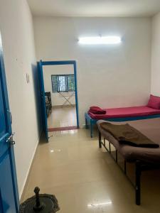 Cette chambre dispose d'un lit et d'un couloir avec un miroir. dans l'établissement The Maze House Anjuna!, à Anjuna