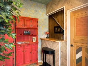 a kitchen with red cabinets and a counter at Yufuin Onsen 8A1 Yaeichi in Yufuin +41 photos