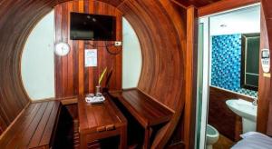 a wooden room with a desk and a sink in a boat at Prew Lom Chom Nam Resort in Ban Phan Sadet Nai +99 photos