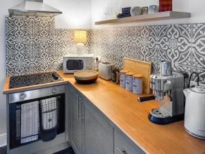 a kitchen with a counter top with a microwave at Novena - Uk50586 in Penrith