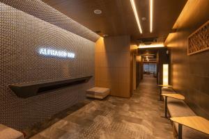 a lobby of a restaurant with a sign on the wall at ALPHABED INN Hakata station front in Fukuoka