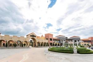 a courtyard of a building with a cloudy sky at Verona Boutique Hotel - The Verona Co., Ltd in Ban Wang Khon Daeng