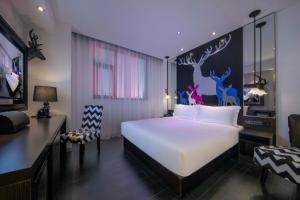 Una cama o camas en una habitación de Orange Hotel