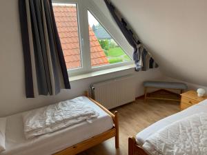 a bedroom with a bed and a large window at Baltic Joy in Damp +16 photos