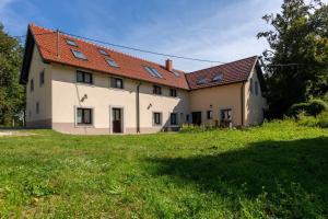 une grande maison blanche avec une cour gazonnée dans l'établissement Studio Für 4 Personen Ca 106 M Sup2 In Gozd, Krain Innerkrain, à Gozd