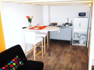 una pequeña cocina con mesa y sillas en una habitación en Orange Suite Studio, en Ámsterdam