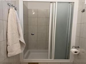 a shower with a glass door in a bathroom at Apartments Magdalena - Bungalow with terrace A1 in Bol +12 photos