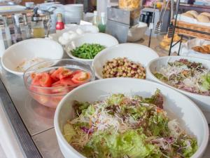 a buffet of bowls of salad and vegetables on a table at Hearton Hotel Higashi-Shinagawa in Tokyo