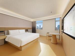 a bedroom with a large bed and a flat screen tv at Dalian Liangyun Hotel in Dalian +193 photos