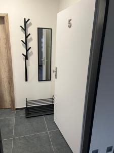 a bathroom with a door and a mirror at Apartmány Příkosice in Příkosice +2 photos