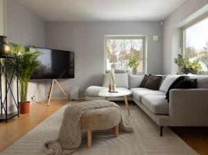 a living room with a couch and a tv at Beautiful house close to center in Gothenburg