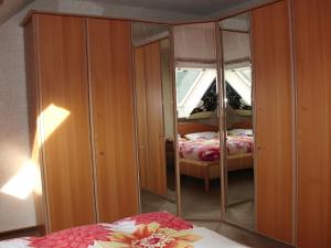 a bedroom with a mirror with a bed and a bed at Gerä Umige Ferienwohnung In Lay Am Moselhang in Koblenz