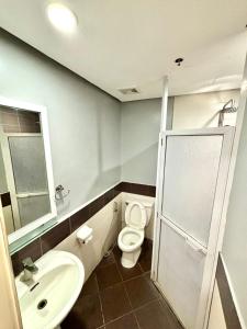 a bathroom with a toilet and a sink at kasa Boutique Hotel Capitol in Cebu City
