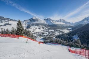 a person is skiing down a snow covered mountain at Corones Suites - Dolomites Residence in Valdaora