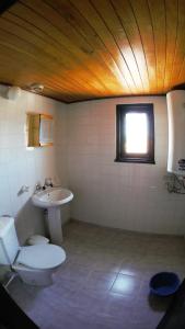a bathroom with a toilet and a sink at Atanasovi House in Shkorpilovtsi