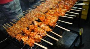 a bunch of food cooking on a grill at Muria Hotel in Semarang