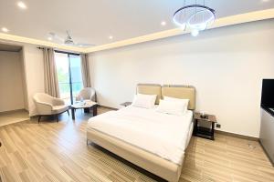 a hotel room with a bed and a tv at Luxury Studio at Monal Murree with Mountain Views in Murree