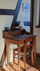 a wooden desk with a lamp and a chair at Les Perles du Ried - Gîte 209 in Boofzheim +38 photos