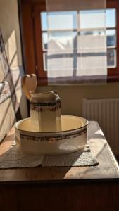 a cup in a bowl on top of a table at Les Perles du Ried - Gîte 209 in Boofzheim