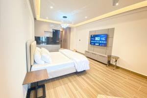 a bedroom with a bed and a flat screen tv at Luxury Studio at Monal Murree with Mountain Views in Murree