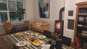 a living room with a table with food on it at Kongsø Homestay - room by Mette&Peter in Bryrup