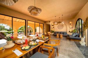 a living room with a table with food on it at Neola Amazing 5 BR Private Pool Villa ZN365 in Tanah Lot