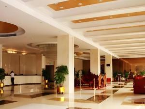 a lobby of a hotel with plants in it at Jie Hao Royal Hotel in Fenghuangwei