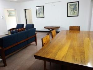 a living room with a table and chairs and a couch at Allison Homes in Kilifi
