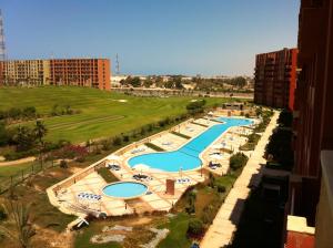 an aerial view of a pool at a resort at Apartment in Golf Porto Marina in El Alamein