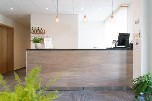a reception desk in a office with a wooden wall at Hotel West in Patreksfjörður
