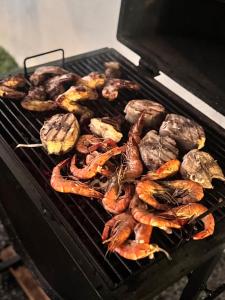 a bunch of different types of food on a grill at Villa Amber Breeze in Mirissa