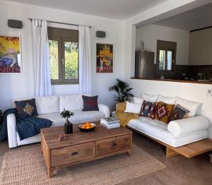 a living room with a couch and a coffee table at Villa Paradisio in EFL +32 photos